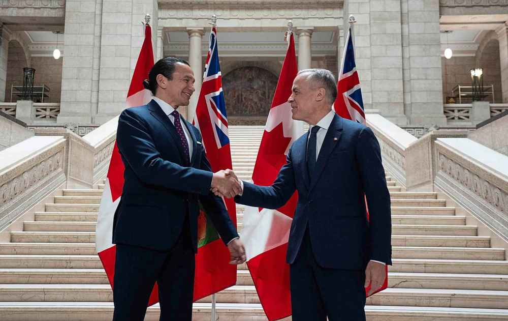 ADRIAN WYLD / THE CANADIAN PRESSManitoba Premier Wab Kinew shakes hands with Liberal Leader Mark Carney as he arrives at the legislature Tuesday.