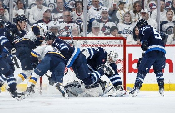 Winnipeg Jets' Luke Schenn (5) defends against St. Louis Blues' Robert Thomas (18) as goaltender Connor Hellebuyck (37) saves the puck in the second period of Saturday's game. (John Woods/The Canadian Press files)