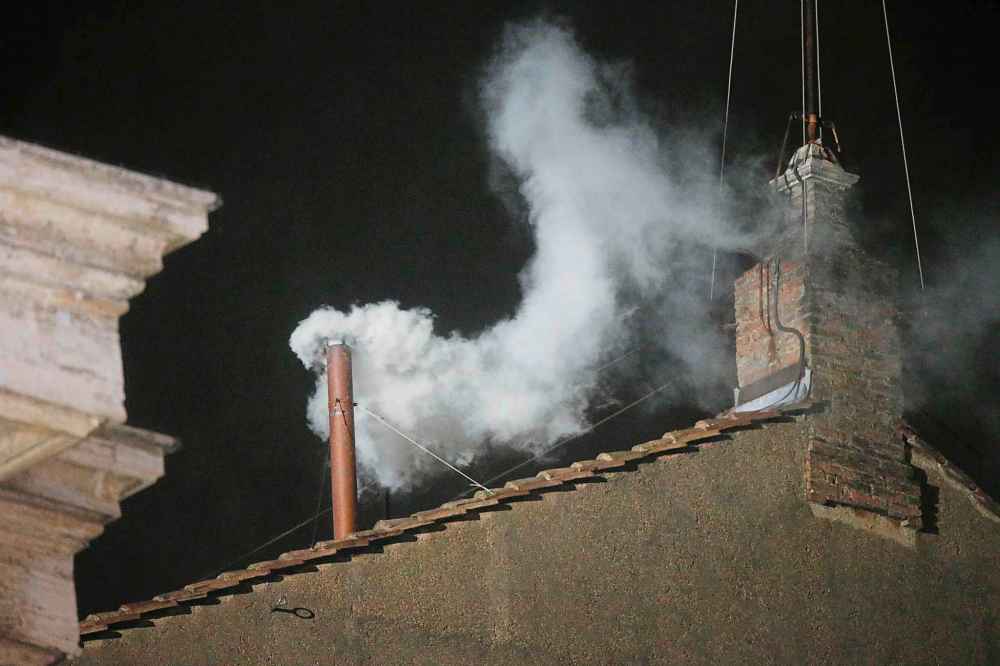 FILE - White smoke is seen billowing out from the chimney of the Sistine Chapel and announcing that a new pope has been elected on Wednesday, March 13, 2013. (AP Photo/Gregorio Borgia, File)