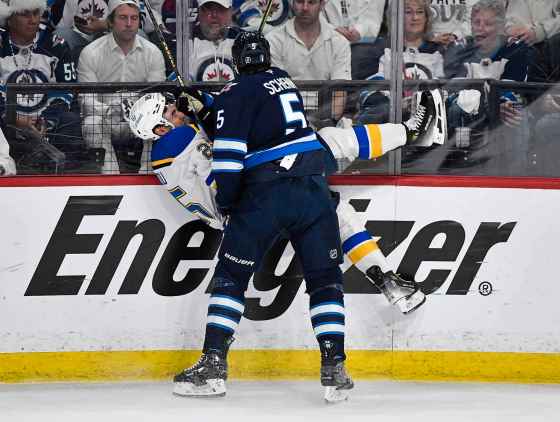 Winnipeg Jets' Luke Schenn checks St. Louis Blues' Jordan Kyrou during the first period on Monday's playoff game. (Fred Greenslade / The Canadian Press)