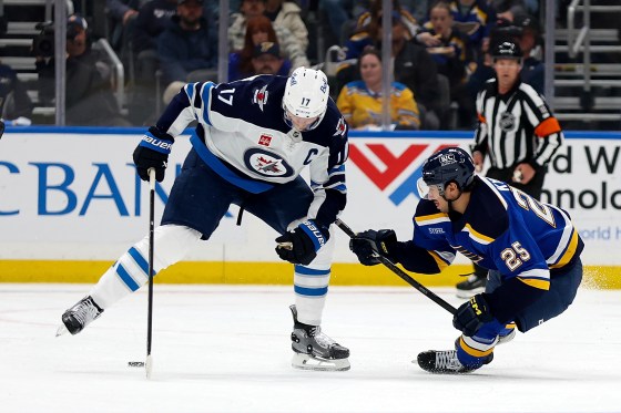 St. Louis Blues' Jordan Kyrou (25) and Winnipeg Jets' Adam Lowry (17) vie for the puck during the third period in Game 3 last week. (Scott Kane / Associated Press files)