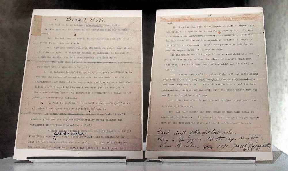 The two pages used by James Naismith to write the first basketball rules is shown during an auction preview at Sotheby's in New York in 2010. (Bebeto Matthews / The Associated Press files)