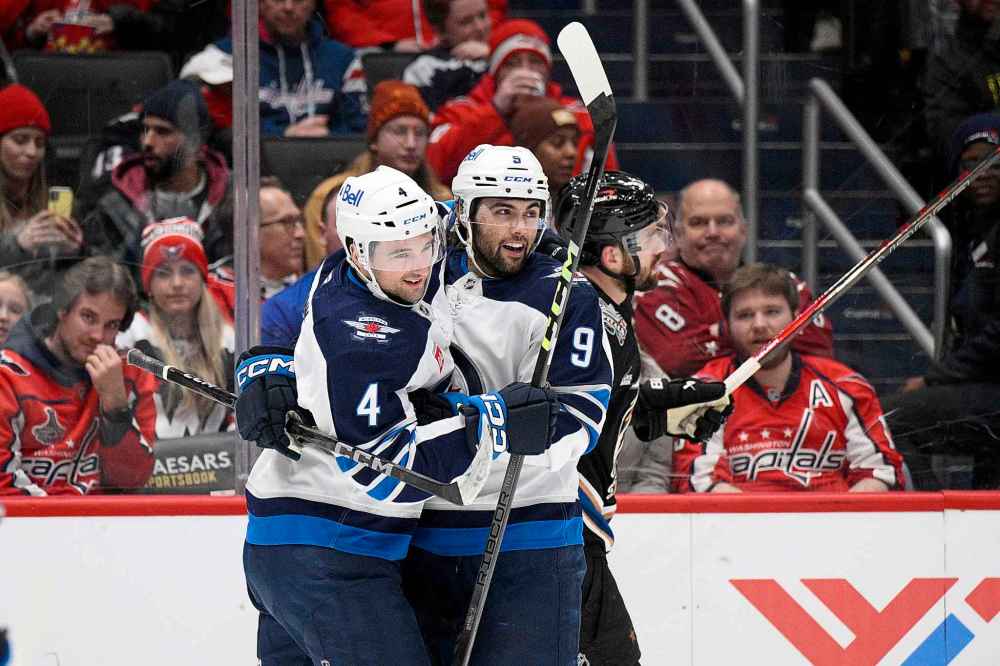 NICK WASS / THE ASSOCIATED PRESS FILES
Alex Iafallo (right) celebrates his goal with defenseman Neal Pionk during a game in Washington in February. Both players signed contract extensions with the Jets this week.