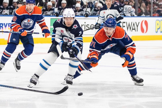 Winnipeg Jets' Vladislav Namestnikov (7) and Edmonton Oilers' Ryan McLeod (71) battle for the puck during a game last season. The teams face off tonight; puck drop is 6 p.m. (Jason Franson / The Canadian Press files)