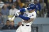 Los Angeles Dodgers' Tommy Edman hits a two-run double during the sixth inning of a baseball game against the Miami Marlins in Los Angeles, Tuesday, April 29, 2025. (AP Photo/Kyusung Gong)