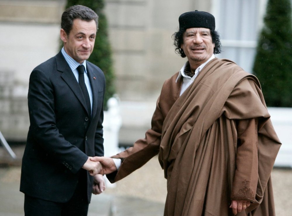 FILE - French President Nicolas Sarkozy, left, greets Libyan leader Col. Moammar Gadhafi upon his arrival on Dec. 10 2007 at the Elysee Palace, in Paris. (AP Photo/Francois Mori, File)
