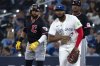 Cleveland Guardians first baseman Carlos Santana, left, jokes with Toronto Blue Jays first baseman Vladimir Guerrero Jr during first inning American League baseball action in Toronto on Saturday, May 3, 2025. THE CANADIAN PRESS/Jon Blacker