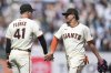 San Francisco Giants' Wilmer Flores (41) celebrates with Willy Adames after a baseball game against the Colorado Rockies in San Francisco, Sunday, May 4, 2025. (AP Photo/Jeff Chiu)