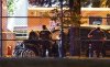 Vancouver Police look over a black car believed to be involved in an incident where a vehicle drove into a crowd at the Lapu Lapu Festival in Vancouver on Saturday, April 26, 2025. THE CANADIAN PRESS/Rich Lam