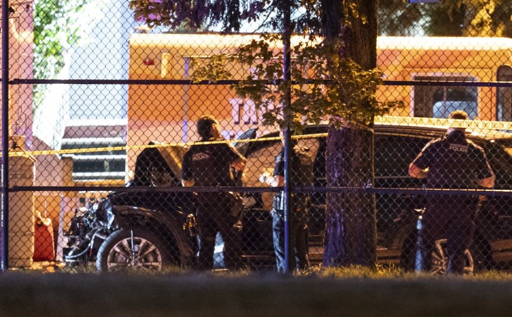 Vancouver Police look over a black car believed to be involved in an incident where a vehicle drove into a crowd at the Lapu Lapu Festival in Vancouver on Saturday, April 26, 2025. THE CANADIAN PRESS/Rich Lam