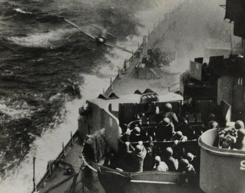 This image provided by the U.S. National Archives shows a scan of a photo of a Japanese Zero fighter plane hitting the USS Missouri in waters off Okinawa, Japan on April 11, 1945. (U.S. National Archives photo no. 80-G-315811A via AP)