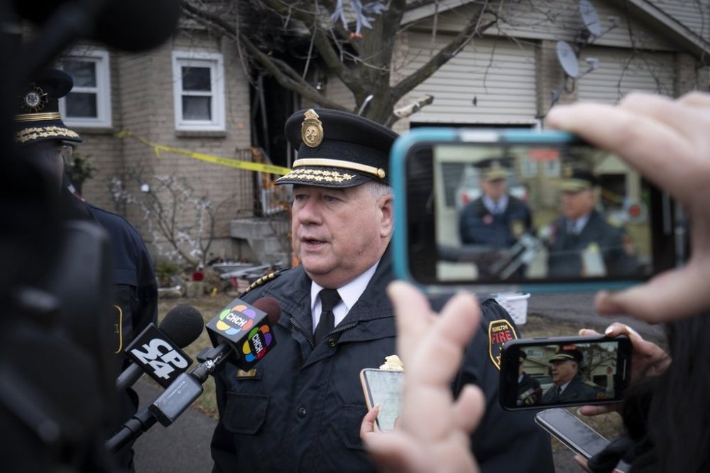 Hamilton Fire Chief Dave Cunliffe speaks to the media near the scene of a fire that claimed the lives of two adults and two children in Hamilton, Ont. on Friday, December 30, 2022. THE CANADIAN PRESS/Peter Power