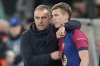 FILE - Barcelona's head coach Hansi Flick, left, gives instructions to Barcelona's Dani Olmo during the Champions League quarterfinals second leg soccer match between Borussia Dortmund and Barcelona, at the Signa-Iduna Park in Dortmund, Germany, April 15, 2025. (AP Photo/Martin Meissner, File)