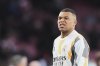 Real Madrid's Kylian Mbappe gestures as he warms up prior to the Champions League quarterfinal first leg soccer match between Arsenal and Real Madrid at the Emirates Stadium in London, Tuesday, April 8, 2025. (AP Photo/Frank Augstein)