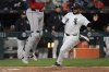 Chicago White Sox's Omar Narváez, right, slides into home to score on a double by Miguel Vargas during the fourth inning of a baseball game against the Boston Red Sox, Friday, April 11, 2025, in Chicago. (AP Photo/Erin Hooley)