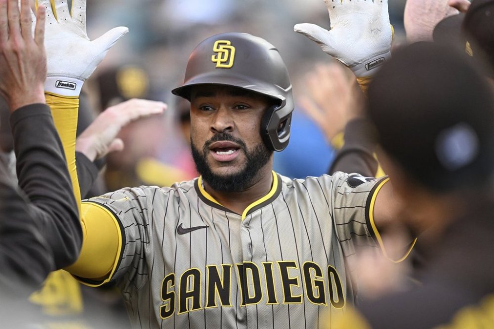 San Diego Padres catcher Elias Díaz (17) celebrates in the dugout after hitting a two-run home run off Detroit Tigers' Jack Flaherty, not pictured, during the second inning of a baseball game, Tuesday, April 22, 2025, in Detroit. (AP Photo/Lon Horwedel)