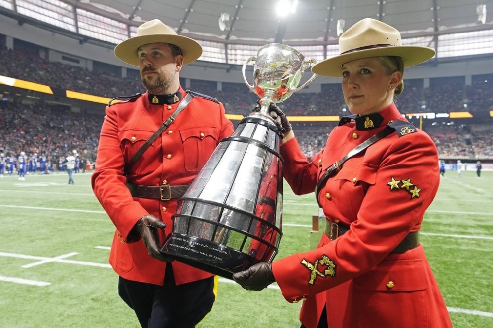 Members of the RCMP carry the Grey Cup trophy before first-half CFL football action at the 111th Grey Cup in Vancouver on Sunday, November 17, 2024. THE CANADIAN PRESS/Frank Gunn