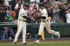 San Francisco Giants' Mike Yastrzemski, right, is congratulated by third base coach Matt Williams after hitting a home run against the Milwaukee Brewers during the third inning of a baseball game in San Francisco, Thursday, April 24, 2025. (AP Photo/Jeff Chiu)