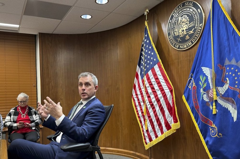 North Dakota Republican Gov. Kelly Armstrong gestures during a meeting at the state Capitol in Bismarck, N.D., Jan. 28, 2025. (AP Photo/Jack Dura)