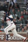 Atlanta Braves outfield Bryan De La Cruz (14) hits a double against the Philadelphia Phillies in the second inning of a baseball game, Thursday, April 10, 2025, in Atlanta. (AP Photo/Mike Stewart)