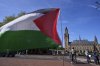 A Palestinian flag flies outside the International Court of Justice, rear, which opened hearings into a United Nations request for an advisory opinion on Israel's obligations to allow humanitarian assistance in Gaza and the West Bank, in The Hague, Netherlands, Monday, April 28, 2025. (AP Photo/Peter Dejong)