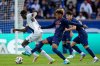 PSG's Desire Doue, center, challenges for the ball with Le Havre's Gautier Lloris, left, during the French League One soccer match between Paris Saint-Germain and Le Havre at the Parc des Princes stadium in Paris, Saturday, April 19, 2025. (AP Photo/Michel Euler)
