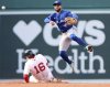 Toronto Blue Jays shortstop Bo Bichette, top, throws to first base over Boston Red Sox's Jarren Duran (16) to complete a double play in the third inning of a baseball game Thursday, April 10, 2025, in Boston. (AP Photo/Jim Davis)