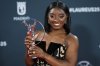 Simone Biles celebrates her Laureus World Sportswoman of the Year award, during the 2025 Laureus World Sports Awards ceremony in Madrid, Spain, Monday, April 21, 2025. (AP Photo/Manu Fernandez)
