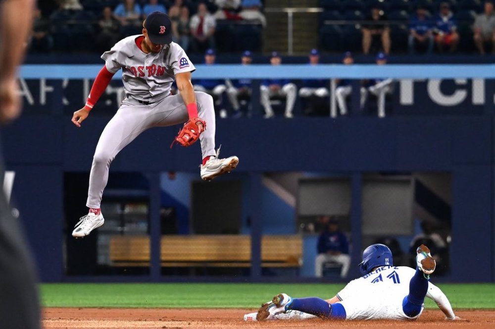 Toronto Blue Jays shortstop Bo Bichette, right, slides into second base with a steal ahead of a tag by Boston Red Sox second baseman Kristian Campbell in first inning MLB action in Toronto on Tuesday, April 29, 2025. THE CANADIAN PRESS/Jon Blacker