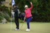 Madelene Sagstrom, right, gestures to the crowd after making a hole-in-one on the ninth hole during the first round of the LPGA's JM Eagle LA Championship golf tournament at El Caballero Country Club, Thursday, April 17, 2025, in Los Angeles. (AP Photo/William Liang)