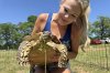 Tiffany Emanuel holds her pet tortoise, Myrtle, in Kokomo, Miss., on Thursday, April 15, 2025. (AP Photo/Sophie Bates)