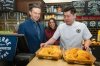 Conservative Leader Pierre Poilievre, left to right, Anaida Poilievre, and Stone Yu, owner of Lucullus Bakers & Roasters, serve pineapple buns to visitors at the bakery in Unionville, Ont., on Monday, April 21, 2025. THE CANADIAN PRESS/Laura Proctor