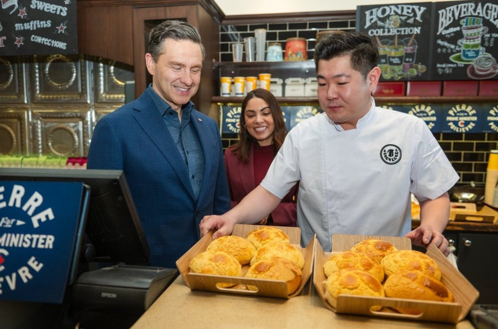 Conservative Leader Pierre Poilievre, left to right, Anaida Poilievre, and Stone Yu, owner of Lucullus Bakers & Roasters, serve pineapple buns to visitors at the bakery in Unionville, Ont., on Monday, April 21, 2025. THE CANADIAN PRESS/Laura Proctor
