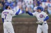 Chicago Cubs' Dansby Swanson (7), left, and Ian Happ (8) celebrate their team's win over the Arizona Diamondbacks in a baseball game Saturday, April 19, 2025, in Chicago. (AP Photo/Erin Hooley)