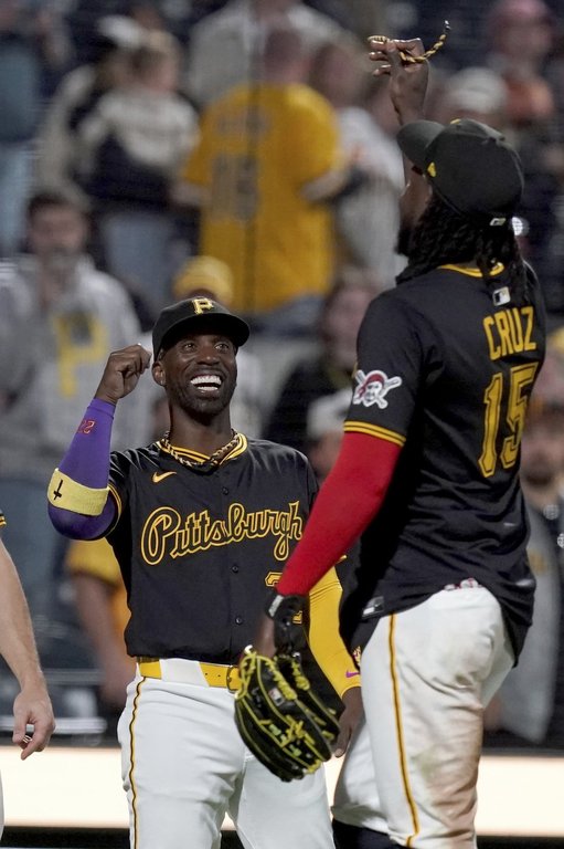 Pittsburgh Pirates' Andrew McCutchen, left, celebrates with Oneil Cruz, right, after defeating the Washington Nationals in a baseball game Monday, April 14, 2025, in Pittsburgh. (AP Photo/Matt Freed)