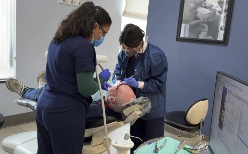 A patient receives a dental procedure at Salt Lake Donated Dental Services, a clinic serving low-income Utah residents, Monday, May 5, 2025, in Salt Lake City, Utah. (AP Photo/Hannah Schoenbaum)