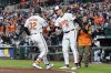 Baltimore Orioles' Ryan O'Hearn (32) celebrates with Gunnar Henderson (2) after hitting a three-run home run during the third inning of a baseball game against the Cleveland Guardians, Thursday, April 17, 2025, in Baltimore. (AP Photo/Stephanie Scarbrough)