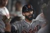 Detroit Tigers' Gleyber Torres is congratulated by teammates in the dugout after hitting a solo home run during the third inning of a baseball game against the Los Angeles Dodgers Friday, March 28, 2025, in Los Angeles. (AP Photo/Mark J. Terrill)