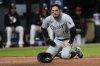 Chicago White Sox's Mike Tauchman (18) kneels after being tagged out by Cleveland Guardians catcher Austin Hedges in the ninth inning of a baseball game in Cleveland, Wednesday, April 9, 2025. (AP Photo/Sue Ogrocki)
