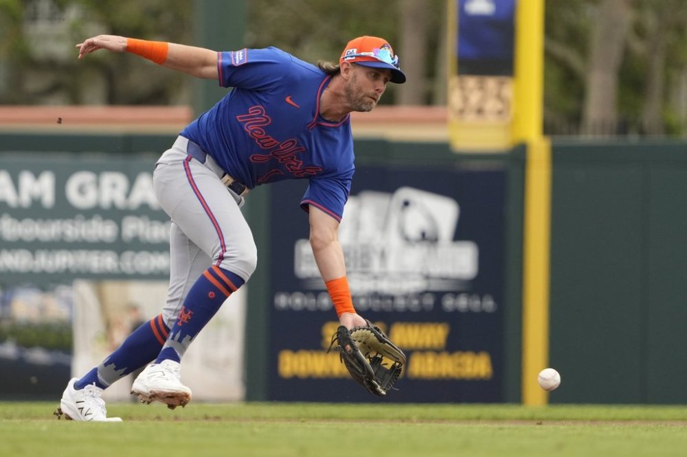 FILE - New York Mets second baseman Jeff McNeil handles a ground out by Miami Marlins' Kyle Stowers during the first inning of a spring training baseball game Wednesday, Feb. 26, 2025, in Jupiter, Fla. (AP Photo/Jeff Roberson,File)