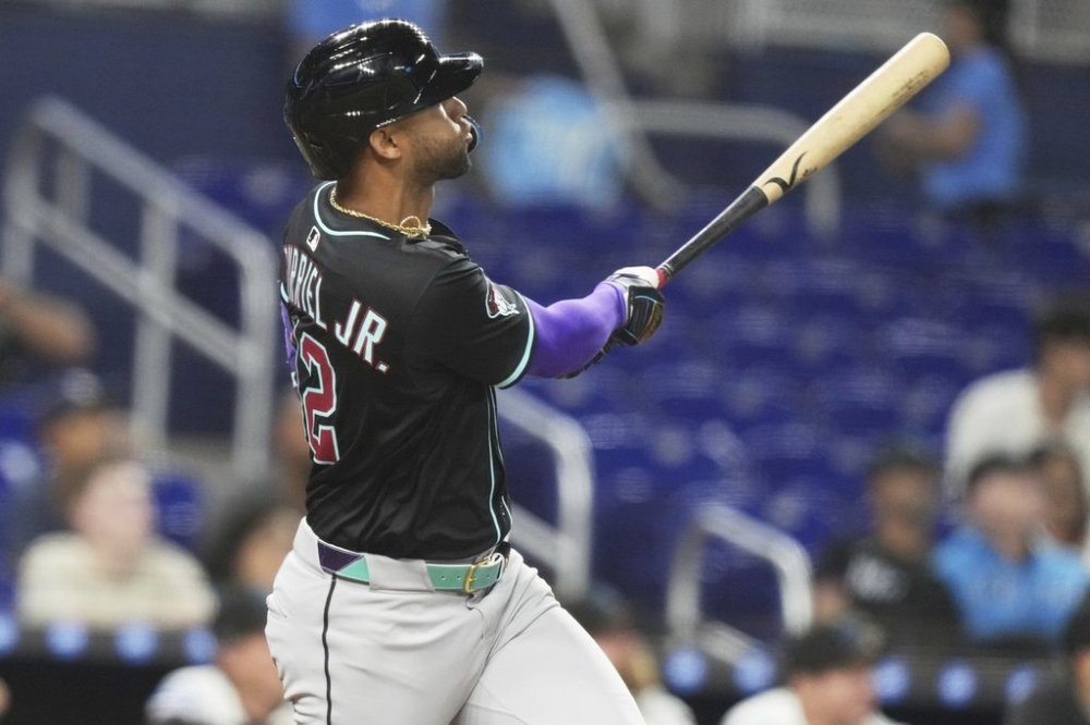 Arizona Diamondbacks' Lourdes Gurriel Jr. watches after hitting a two run home run during the eighth inning of a baseball game against the Miami Marlins, Wednesday, April 16, 2025, in Miami. (AP Photo/Lynne Sladky)