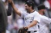 Colorado Rockies relief pitcher Zach Agnos is congratulated after a baseball game against the Atlanta Braves Wednesday, April 30, 2025, in Denver. (AP Photo/David Zalubowski)