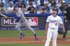 Chicago Cubs' Pete Crow-Armstrong, left, heads to first for a solo home run as Los Angeles Dodgers relief pitcher Blake Treinen watches during the seventh inning of a baseball game Sunday, April 13, 2025, in Los Angeles. (AP Photo/Mark J. Terrill)