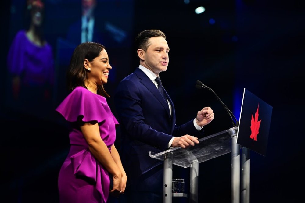 Conservative Leader Pierre Poilievre speaks to supporters with his wife Anaida Poilievre at his campaign headquarters on election night in Ottawa on Tuesday, April 29, 2025. THE CANADIAN PRESS/Spencer Colby