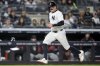 New York Yankees' Austin Wells scores after Oswaldo Cabrera reaches on a throwing error by Arizona Diamondbacks first baseman Josh Naylor during the fourth inning of a baseball game, Tuesday, April 1, 2025, in New York. (AP Photo/Julia Demaree Nikhinson)
