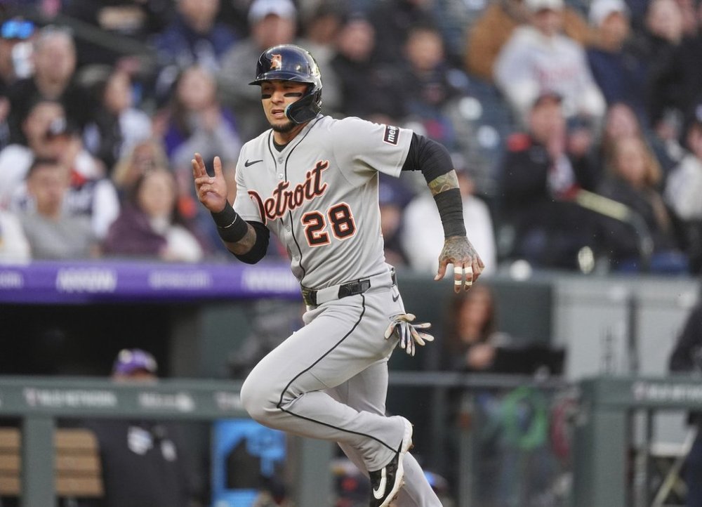 Detroit Tigers' Javier Báez scores on a sacrifice fly hit by Gleyber Torres off Colorado Rockies starting pitcher Chase Dollander in the third inning of a baseball game Wednesday, May 7, 2025, in Denver. (AP Photo/David Zalubowski)