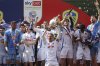 Leeds United's Ethan Ampadu and teammates celebrate with the trophy after being crowned champions following the English Football League Championship soccer match against Plymouth Argyle, at Home Park, in Plymouth, England, Saturday May 3, 2025. (Steven Paston/PA via AP)