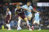 Manchester City's Omar Marmoush, right, challenges for the ball with Aston Villa's Matty Cash during the English Premier League soccer match between Manchester City and Aston Villa at Etihad stadium in Manchester, England, Tuesday, April 22, 2025. (AP Photo/Jon Super)