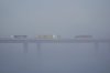 FILE - Trucks carrying shipping containers cross the Long Beach International Gateway Bridge at the Port of Long Beach, Calif., April 8, 2025. (AP Photo/Damian Dovarganes, File)