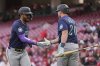 Seattle Mariners' Julio Rodríguez, left, celebrates with Seattle Mariners Luke Raley, right, after scoring on a double hit by Randy Arozarena in the first inning of a baseball game against the Cincinnati Reds, Wednesday, April 16, 2025, in Cincinnati. (AP Photo/Carolyn Kaster)